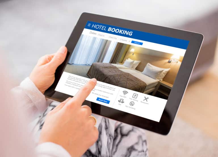 Person booking a hotel room on a tablet